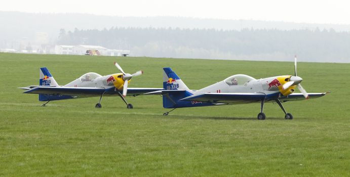 Plasy, Czech Republic - April 27, 2013: The Flying Bulls Aerobatics Team on the Airshow "The Day on Air". The team fly four modified Zlin Z-50 LX aircraft, painted in the colors of Red Bull energy drink for sponsorship reasons