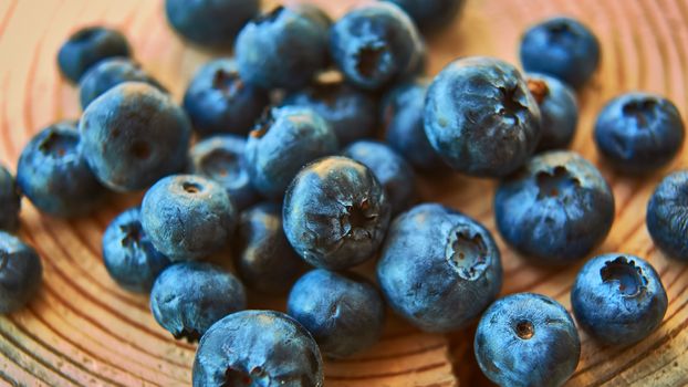 Freshly picked blueberries on wooden background. Shallow dof