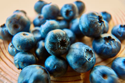 Freshly picked blueberries on wooden background. Shallow dof