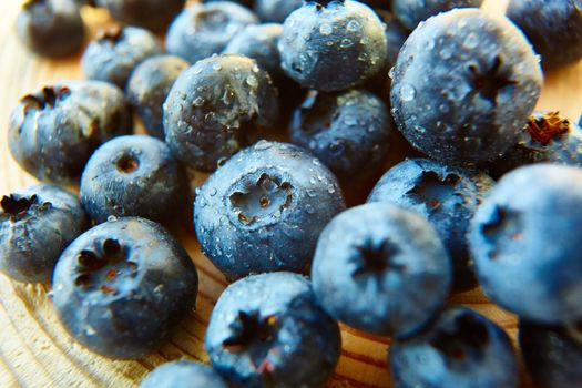 Freshly picked blueberries on wooden background. Shallow dof