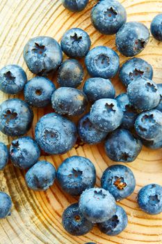 Freshly picked blueberries on wooden background. Shallow dof