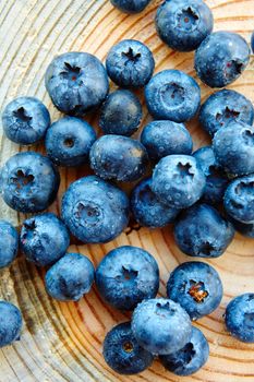 Freshly picked blueberries on wooden background. Shallow dof