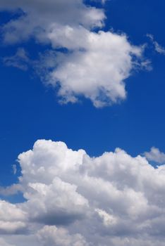 The blue sky and beautiful white clouds.