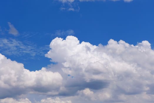 The blue sky and beautiful white clouds.