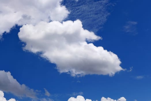 The blue sky and beautiful white clouds.