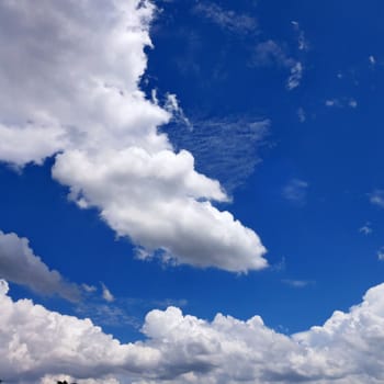 The blue sky and beautiful white clouds.