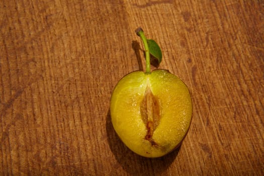 fresh plums on wooden table. Shallow dof