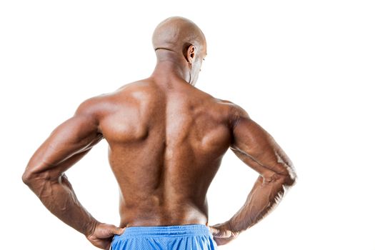 Toned and ripped lean muscle fitness man standing in front of a white background.