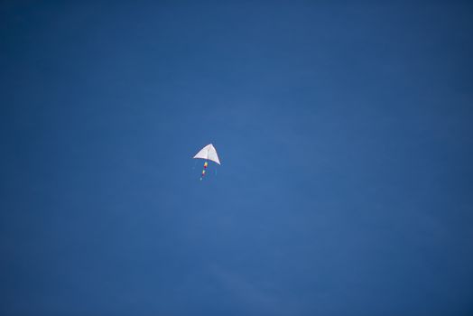 A bright colored kite soaring high in the sky