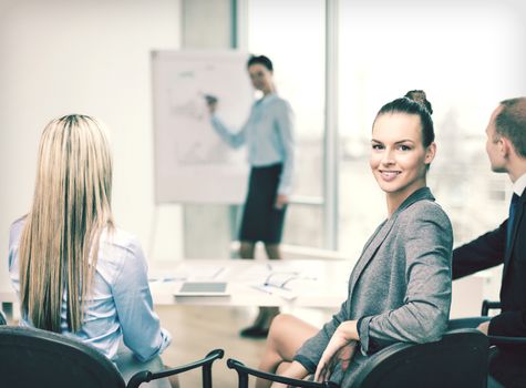 business and office concept - smiling businesswoman with team in office