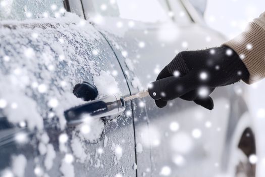 transportation, people, season and ownership concept - close up of man with car key outdoors