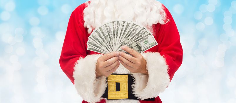 christmas, holidays, winning, currency and people concept - close up of santa claus with dollar money over blue lights background