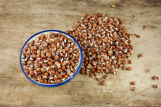 Portion of nature peas in bowls on wooden background.