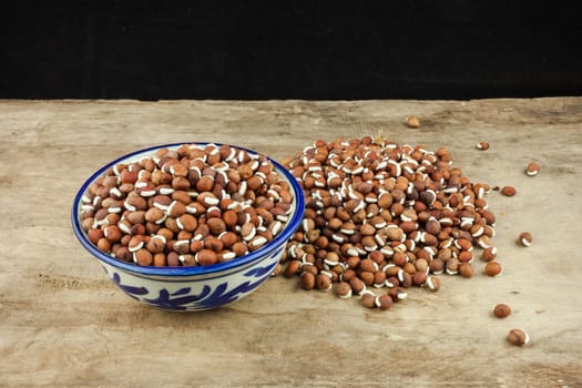 Portion of nature peas in bowls on wooden background.