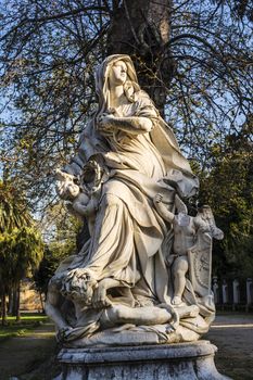 Woman statue with angels in Villa Giulia, Palermo, Italy