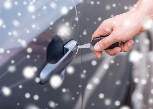 transportation, people, season and ownership concept - close up of man with car key outdoors