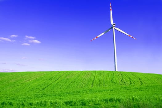 Windmill conceptual image. Windmill on the green field.