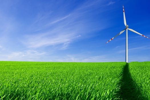 Windmill conceptual image. Windmill on the green field.