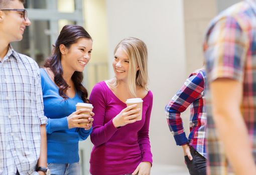 education, high school, friendship, drinks and people concept - group of smiling students with paper coffee cups