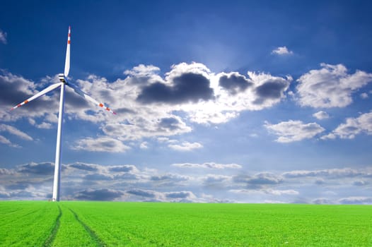 Windmill conceptual image. Windmill on the green field.