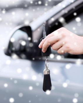 transportation, people, season and ownership concept - close up of man with car key outdoors