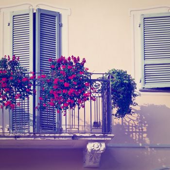 Renovated Facade of the Old Italian House with Balcony Decorated with Fresh Flowers, Instagram Effect 