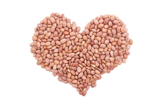 Pinto beans in a heart shape, isolated on a white background