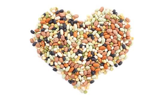 Mixed dried beans in a heart shape, isolated on a white background