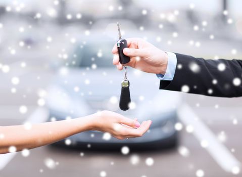 transportation, people, season and ownership concept - close up of man with car key outdoors