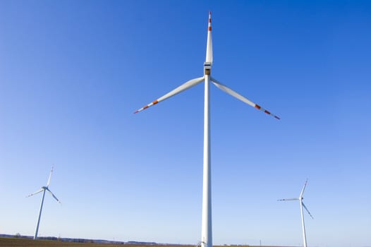 Windmill conceptual image. Windmills against the blue sky.