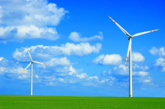 Windmill conceptual image. Windmills on the green field.