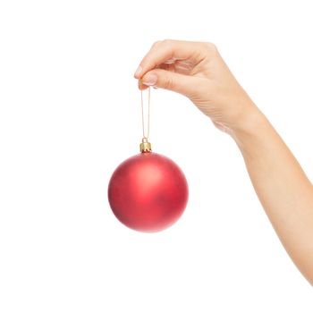 christmas, decoration, holidays and people concept - close up of woman hand holding christmas ball