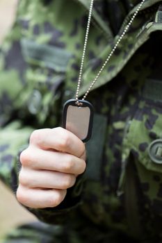 war, army and people concept - close up of young soldier in military uniform