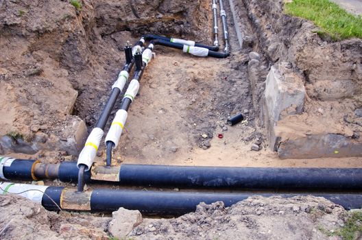  plastic modern technology black heating pipes in trench near city house