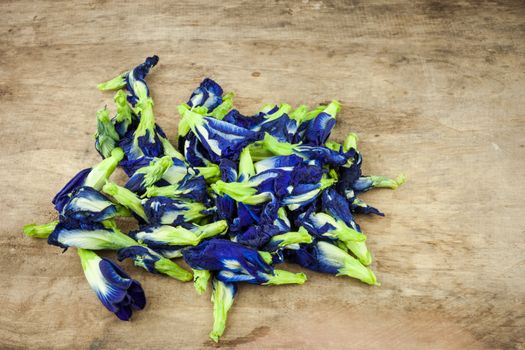 Fresh Butterfly pea flower, Clitoria ternatea on wooden plank.