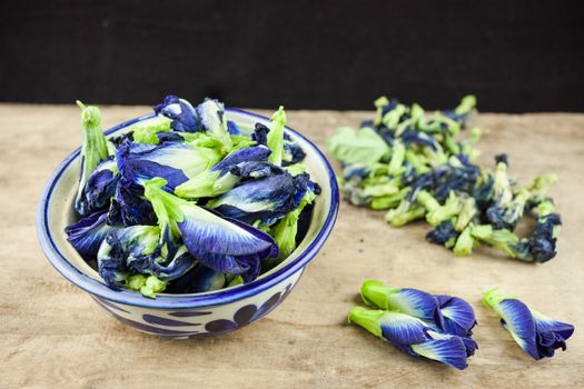 Fresh Butterfly pea flower, Clitoria ternatea on wooden plank.