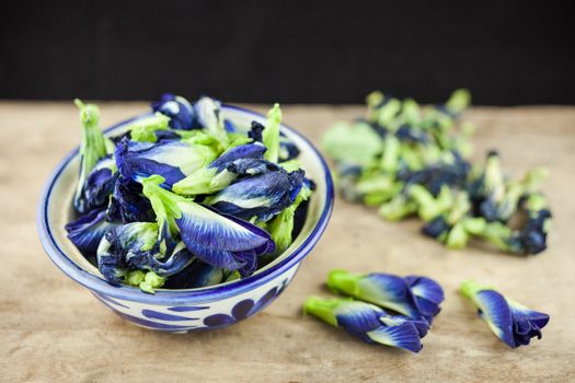 Fresh Butterfly pea flower, Clitoria ternatea on wooden plank.