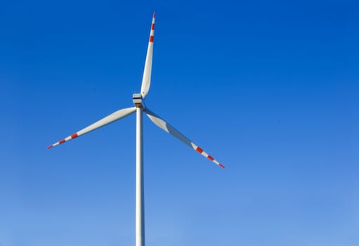 Windmill conceptual image. Windmill against the blue sky.