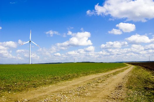 Windmill conceptual image. Windmill on the green field.