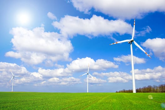 Windmill conceptual image. Windmills on the green field.