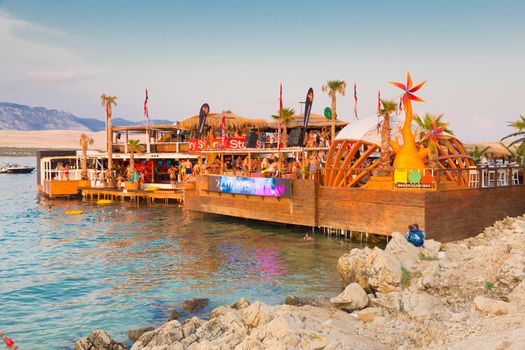 Croatia, Pag Island - July 25, 2015: Crowd of young people partying on a hot summer day on Zrce beach, Novalja, Pag island, Croatia. Zrce beach is the most popular party destination on Adriatic sea.