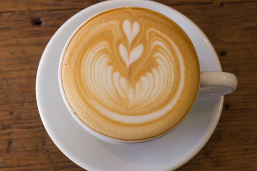 Coffee latte art on the wood desk