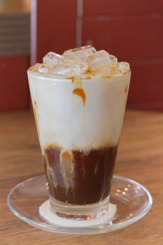 Ice Coffee with milk on the wood desk