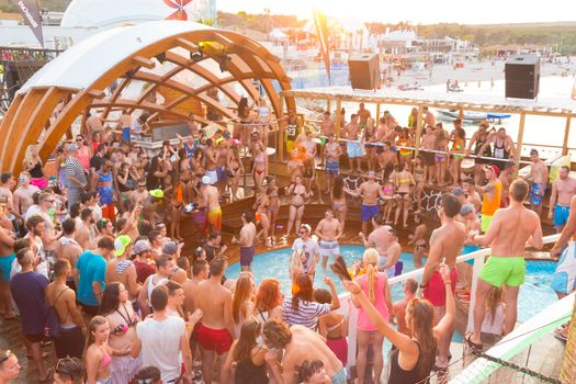 Croatia, Pag Island - July 25, 2015: Crowd of young people partying on a hot summer day on Zrce beach, Novalja, Pag island, Croatia. Zrce beach is the most popular party destination on Adriatic sea.
