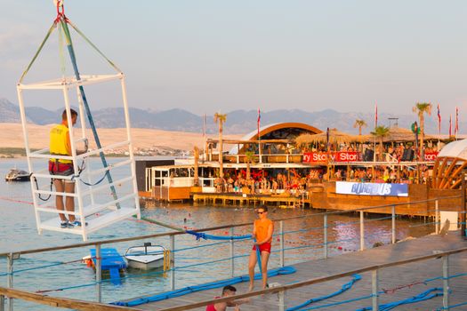 Croatia, Pag Island - July 24, 2015: Crowd of young people partying on a hot summer day on Zrce beach, Novalja, Pag island, Croatia. Zrce beach is the most popular party destination on Adriatic sea.