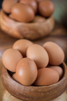 Fresh eggs at wooden plate closeup