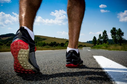 Runner getting ready to run on a street in the middle of nowhere