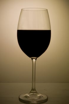 A red glass of wine on a dark background
