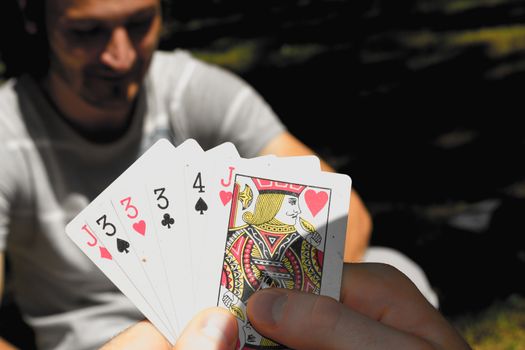 Two friends playing cards in a park