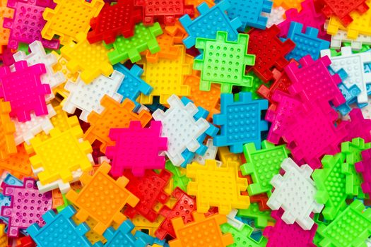 Some colorful jigsaw puzzle pieces close up.